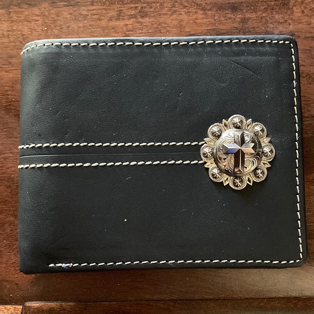 A Black Wallet with lots of storage available and has many pockets for cards.